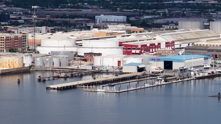 Baltimore Maryland USA - 8 25 2025: Aerial footage of office buildings and factories along the Patapsco River in Baltimore Maryland USA