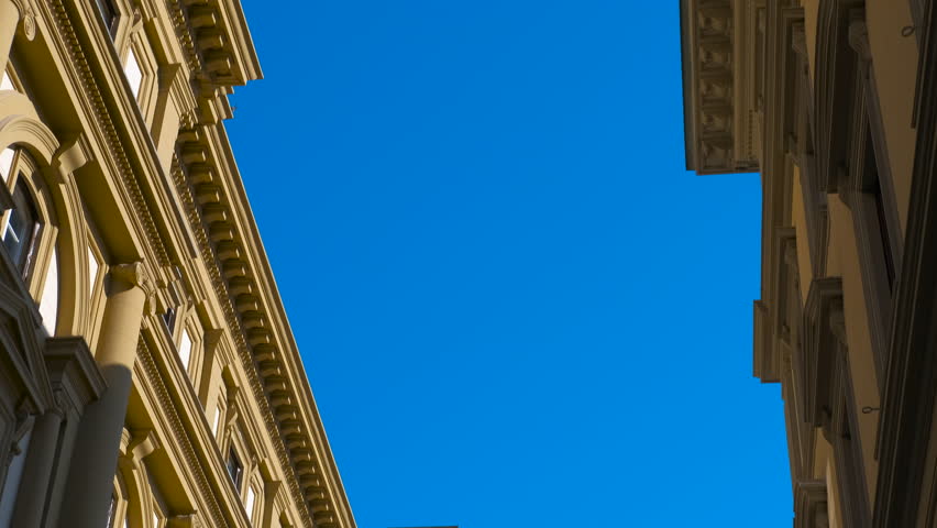 Palazzo delle poste centrali in florence revealing under blue sky. Majestic palazzo delle poste centrali in florence gradually reveals itself under a vibrant blue sky, showcasing architectural details