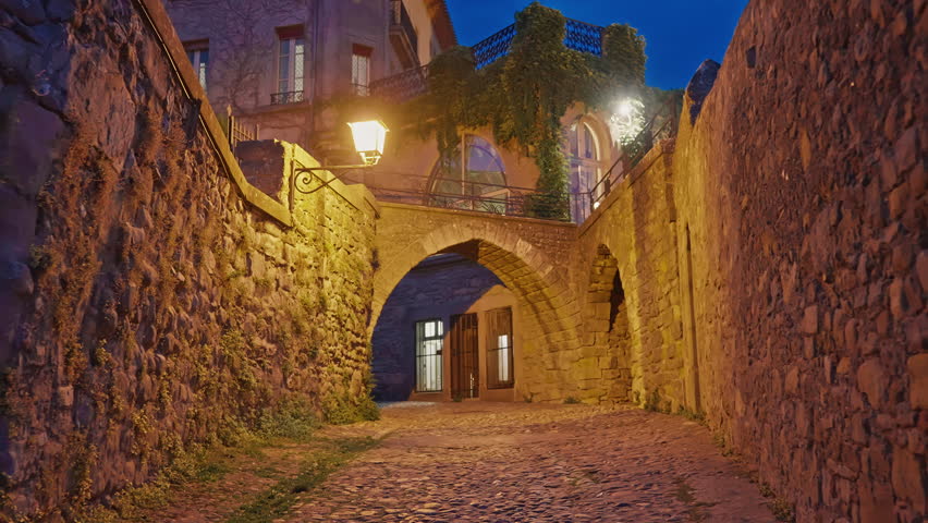 Strolling at night through the streets of the ancient medieval castle-fortress city of Carcassonne, France
