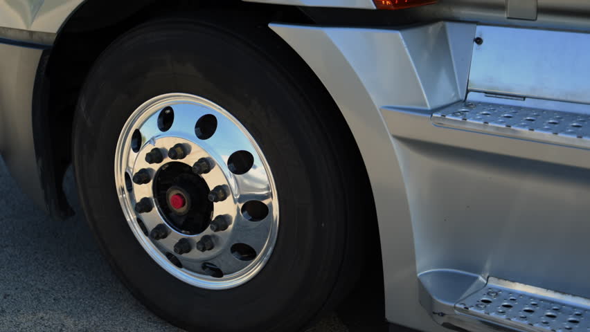 POV view of delivery truck tire wheel spinning on a scenic state highway. Logistics and transportation concept. 