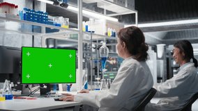 Scientist typing on keyboard, using green screen computer program in laboratory, driving treatment discovery. Expert using bioinformatics software on chroma key PC in sterile lab, camera A - Powered by Shutterstock - Get 15% off with code: PIKWIZARD15