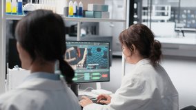 Medical laboratory technician checking time, waiting to finish shift, processing patient data. Research facility worker using PC to do genetic analysis diagnostics checking wrist watch clock, camera B - Powered by Shutterstock - Get 15% off with code: PIKWIZARD15