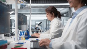 Nanotechnology researcher checking time, waiting to finish shift, processing patient data. Lab employee using PC to do genetic analysis diagnostics checking wrist watch clock, camera A - Powered by Shutterstock - Get 15% off with code: PIKWIZARD15