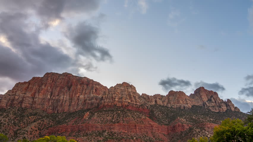 Timelapse of Dramatic red rock mountains under a cloudy sky in the Early Morning