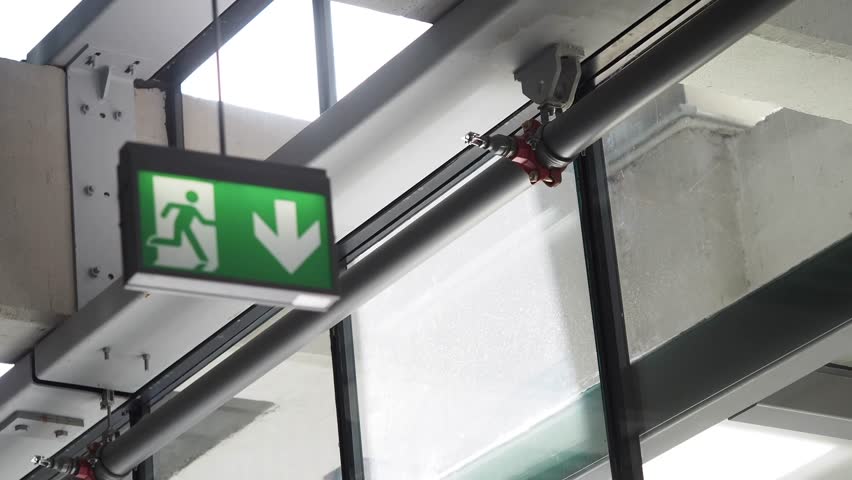 Emergency Exit Sign with Down Arrow and Person Icon 4k