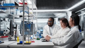 Diverse team of research facility professional using PC software to evaluate genetic marker associated with disease risk. Multiracial coworkers study DNA strand mapping, camera A - Powered by Shutterstock - Get 15% off with code: PIKWIZARD15