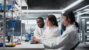 Multiracial lab technicians at PC desk looking at 3D molecular model. Diverse nanotechnology researchers using bioengineering program on PC in medical lab displaying DNA data, camera A - Powered by Shutterstock - Get 15% off with code: PIKWIZARD15