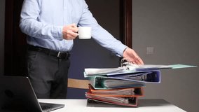 Man handling stack of binders, managing paperwork overload - Powered by Shutterstock - Get 15% off with code: PIKWIZARD15