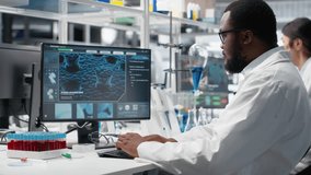Molecular biologist uses computer program displaying DNA data, removing eyeglasses. African american man confused by bioinformatics genomics software analysis on PC in lab, camera B - Powered by Shutterstock - Get 15% off with code: PIKWIZARD15