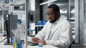 Chemist uses pipette to transfer liquid into test tube containing blue solution at laboratory bench. African american man in research facility does pipetting procedure with chemical reagent, camera B - Powered by Shutterstock - Get 15% off with code: PIKWIZARD15