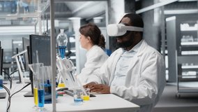 Lab engineer at PC desk using VR goggles to look at 3D molecular model, rotating it. Nanotechnology researcher using virtual reality simulation in medical lab, doing hand gestures, camera B - Powered by Shutterstock - Get 15% off with code: PIKWIZARD15