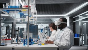 Lab engineer at PC desk using VR goggles to look at 3D molecular model, rotating it. Nanotechnology researcher using virtual reality simulation in medical lab, doing hand gestures, camera A - Powered by Shutterstock - Get 15% off with code: PIKWIZARD15