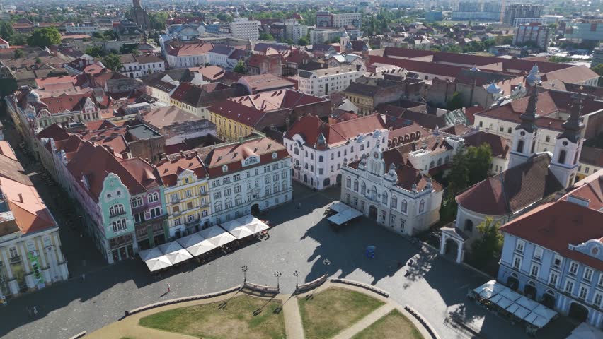Scenic aerial view over Timisoara’s Union Square, featuring historic buildings, religious landmarks, and architectural details.