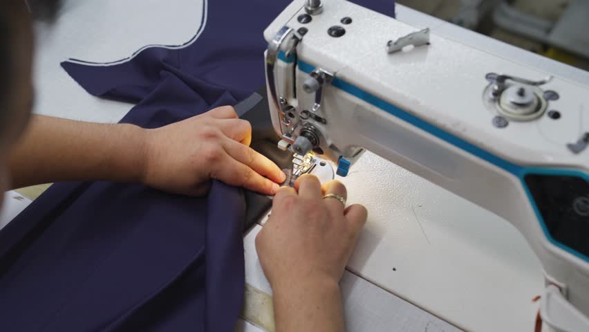 Industrial Sewing Machine in Action. Close-up Textile Factory Footage
