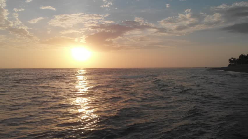 Captivating sunset over Costa del Sol's calm sea, with golden hues reflecting on gentle waves. A serene and peaceful evening ambiance, perfect for relaxation and nature appreciation.