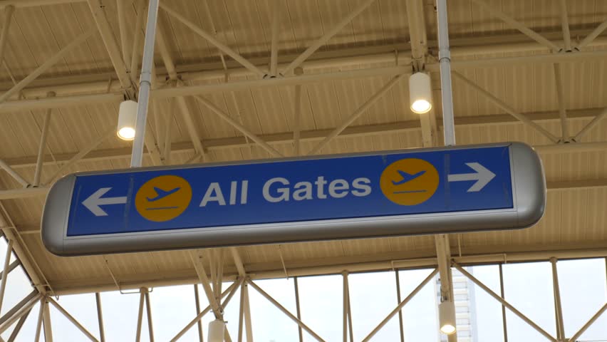 Dynamic view of airline signs at LAX, Los Angeles. Clean lines and modern architecture under bright daylight. Clear signage guides travelers through this busy aviation hub.