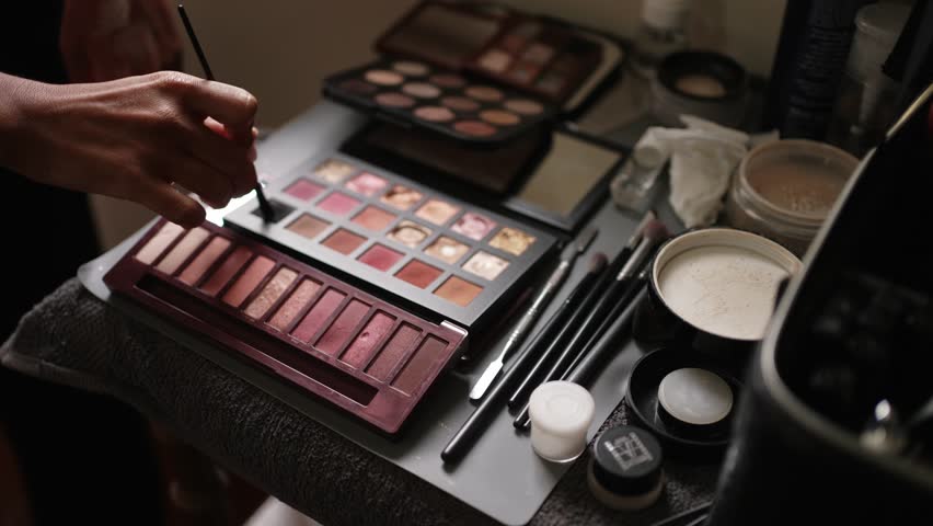 Close up of makeup tools and palettes arranged for wedding styling