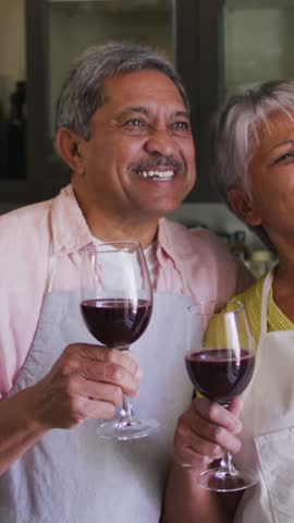 Animation of digital social media people icons over senior couple drinking wine using smartphone. global social medial, connection and communication concept digitally generated video.