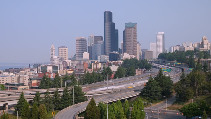 Gorgeous aerial footage captures a breathtaking panorama of downtown Seattle, Washington, showcasing an enchanting sunset glow over the city