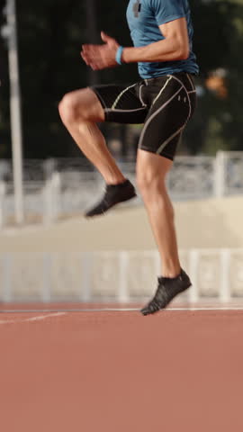 focused runner doing stretching before run vertical slow motion fullHD athlete preparing body morning light discipline strength flexibility awareness motivation balance fitness