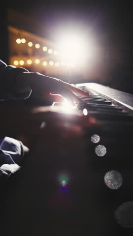 vertical close up of female hands playing piano under warm studio light concept of elegance creativity and art of sound expressing passion focus and harmony through music