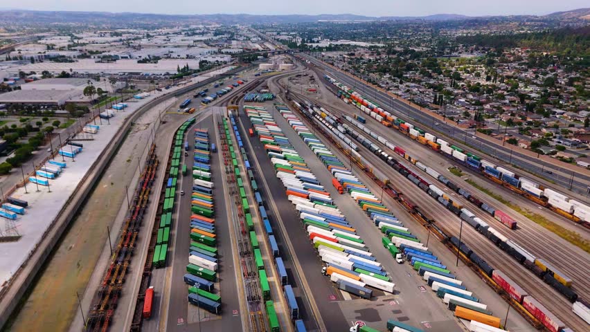 Aerial view of cargo trains and containers at logistics terminal in October 7, 2025
