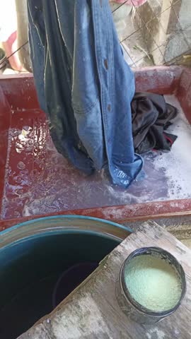 Handwashing and hanging clothes by a Mexican man