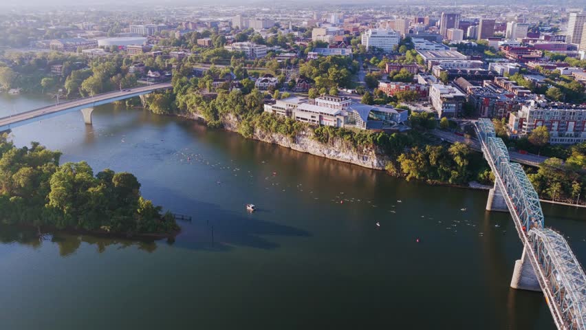 A thrilling aerial view of adventure activities in America—soaring over rugged mountains, vast canyons, and winding rivers from a dynamic drone perspective.