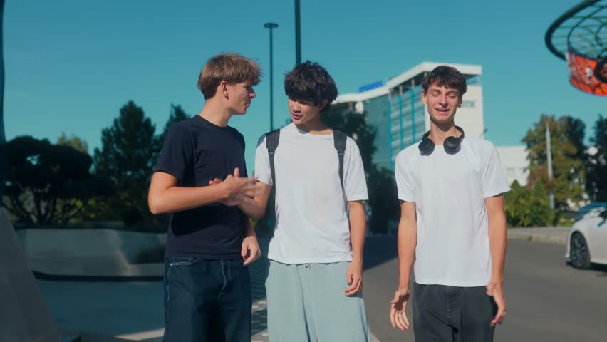 Three teenage boys walking together outdoors in a modern city, smiling and chatting casually. A candid lifestyle moment showing friendship, youth energy, and urban vibes.
