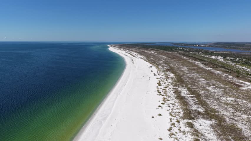 Panorama aerial view of white sandy beach side extending into deep blue Gulf of Mexico, 30A, Florida, USA