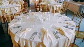 Beautifully decorated round tables with elegant cutlery, glassware, and dinnerware — sophisticated setup for wedding, banquet, or formal dining event. - Powered by Shutterstock - Get 15% off with code: PIKWIZARD15