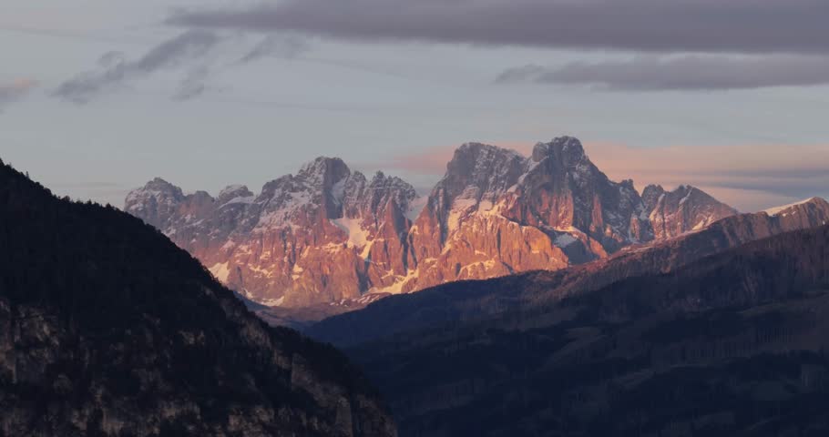 Pale di San Martino at sunset with orange glow, serene mountain view