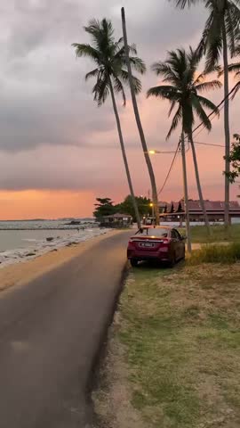 Malacca, Malaysia – 30 Oktober 2025
Beautiful sunset view at the beach in Melaka, Malaysia, with golden light reflecting on calm sea waves and orange-pink evening sky.