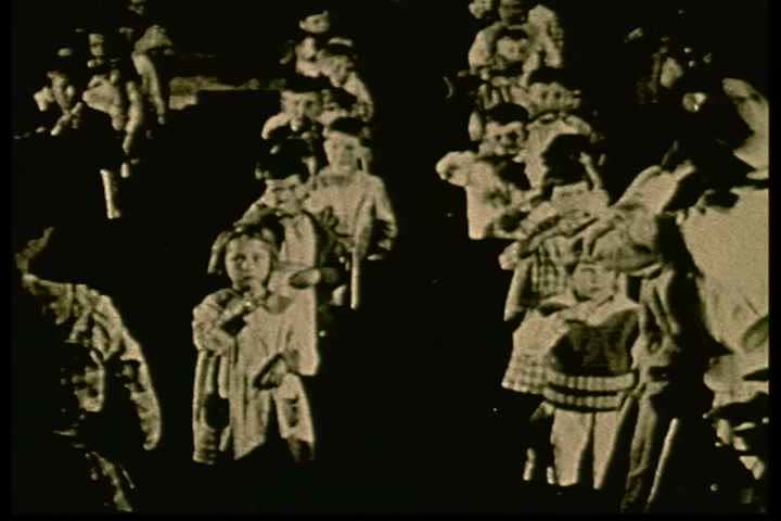 1920s - Archival silent film of a schoolmarm instructing children at Grover Street school on how to brush their teeth.
