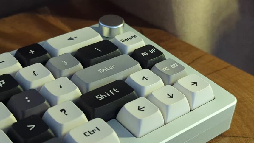 Macro view of mechanical switches and textured keycaps. Monochrome custom keyboard setup. Detailed computer input device, PC gaming, tactile hardware.