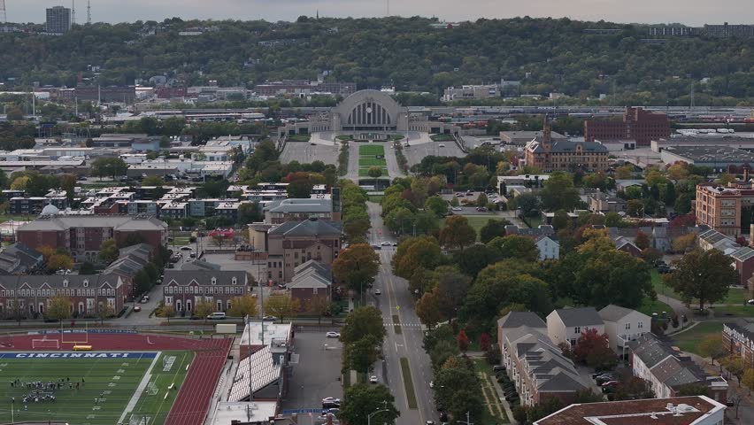 Aerial view of Union Terminal, surrounded by buildings and trees, showcasing urban architecture and lush greenery from above, Cincinnati, Ohio, United States.