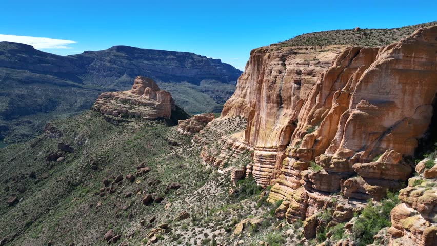 Aerial view of the rugged Apache Trail, with the blue waters of Canyon Lake nestled among the towering cliffs and desert landscape, Apache Junction, Arizona, United States.