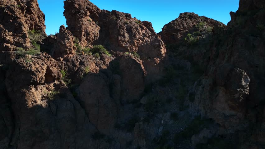 Aerial view of the rugged Superstition Mountain landscape, a vista of textures and tones under a clear sky, Apache Junction, Arizona, United States.