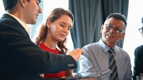 Diverse group of cheerful business professionals is collaborating in an office meeting, reviewing data on a digital tablet and discussing the strategy for a new project - Powered by Shutterstock - Get 15% off with code: PIKWIZARD15