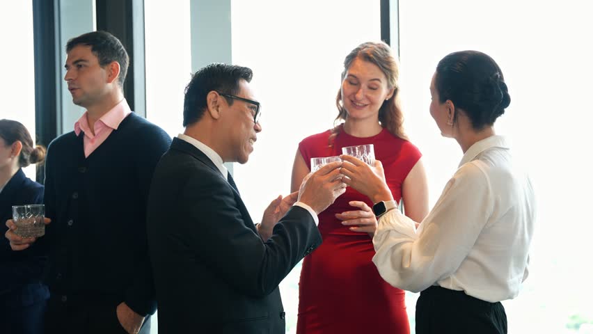 Diverse business colleagues in a friendly, professional conversation during a corporate networking event or New year party. Successful team members building connection and enjoying a social gathering - Powered by Shutterstock - Get 15% off with code: PIKWIZARD15