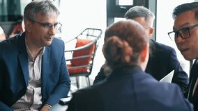 Business meeting with diverse professionals collaborating and discussing strategy at coworking area or restaurant. Corporate team is brainstorming, networking, and planning for success - Powered by Shutterstock - Get 15% off with code: PIKWIZARD15