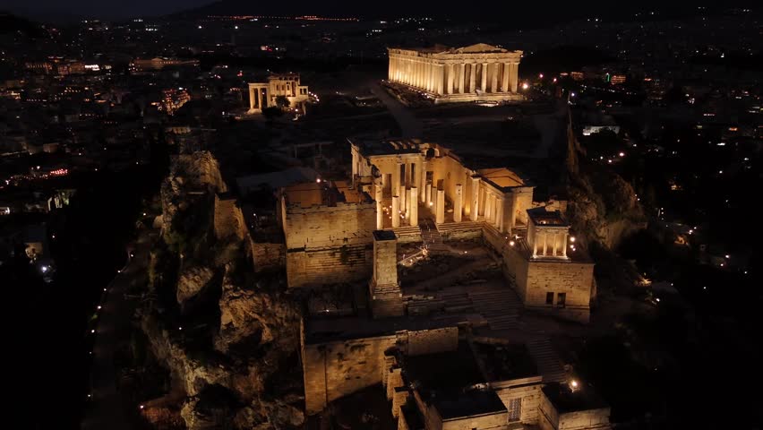 Athens, Aerial view of Beautifully illuminated Acropolis at night, circle pan left slowly,Full view of Panthenon,Erechthenion and entrance of Acropolis in shimmering lights.
