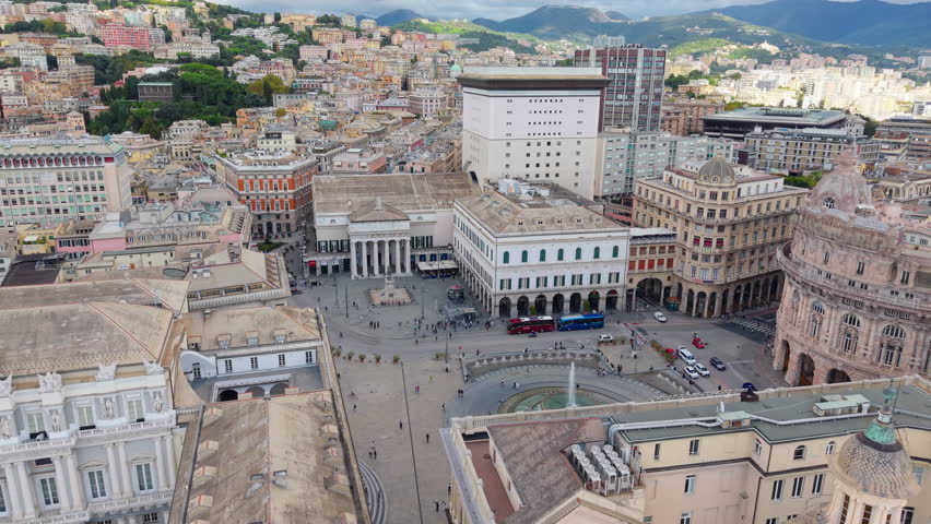 Drone descends and tilts down toward fountain at Piazza De Ferrari in Genoa.