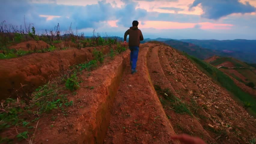 POV of a Freedom man Jump on Mountain Peak at Sunset. having fun and celebrating victory. adventure travel