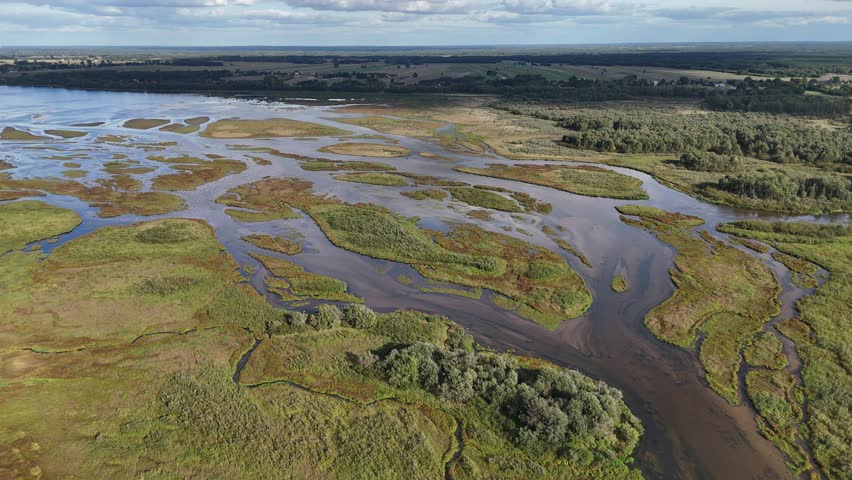 Drone film showing the Warta River delta in Jeziorsko Nature Reserve with wetlands, water channels, marsh areas and natural protected landscape