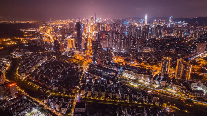 Stunning aerial night view of Shenzhen Luohu district with illuminated skyscrapers and city lights creating a vibrant urban landscape perfect for time lapse photography.