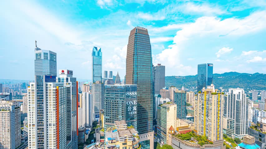 Chongqing business district skyline with Jiefangbei CBD high-rise buildings against blue sky and atmospheric clouds in southwestern China