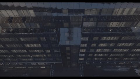 Descending Drone Capturing Windows Modern Glass Building
