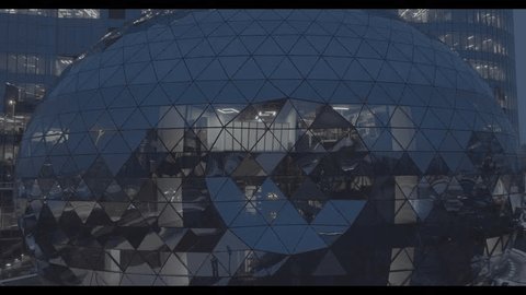 Drone Passing Glass Dome under Illuminated Office