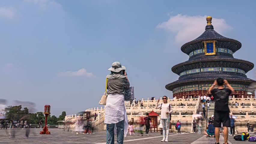 Temple of Heaven in Beijing, China with traditional circular pagoda architecture and tourists visiting this historic religious site and popular travel destination.